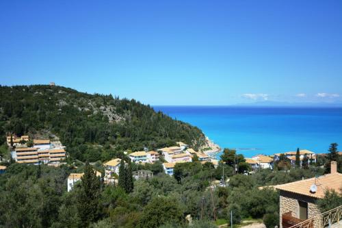 a town on a hill next to the ocean at Agios Nikitas View in Agios Nikitas