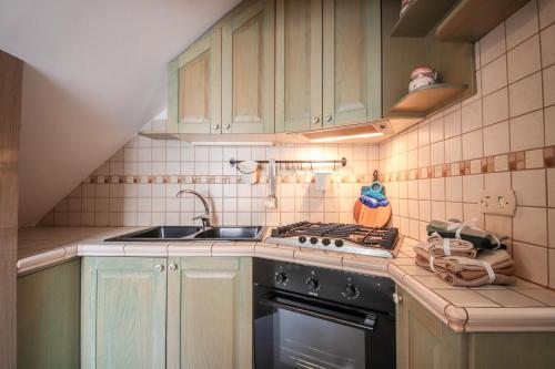 a small kitchen with a sink and a stove at C'era Una Volta in Monopoli