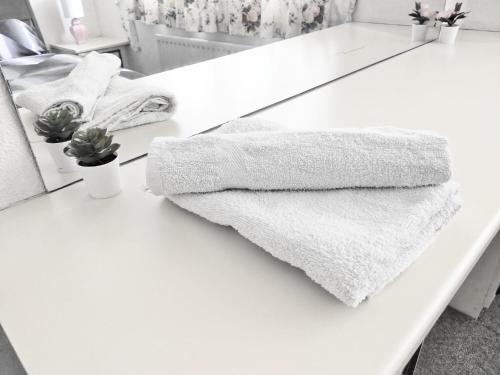 a white counter with two towels on it at EEE Homes Dudley, a retro expression in Lower Gornal