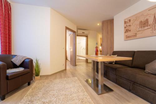 a living room with a couch and a table at Hotel St Georg - Regensburg in Regensburg