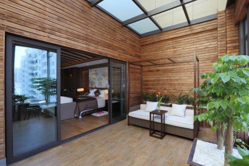 a room with wooden walls and a bedroom at S&N Zhejiang LinHai International Hotel in Linhai