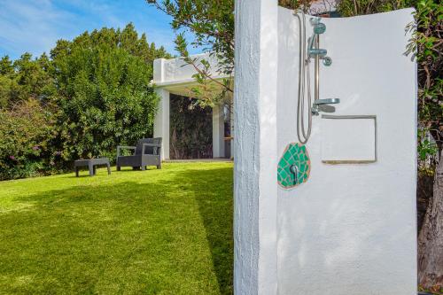 a door to a yard with a bench in the background at A due passi da mare in Abbiadori