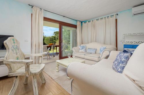 a living room with a couch and a chair at A due passi da mare in Abbiadori