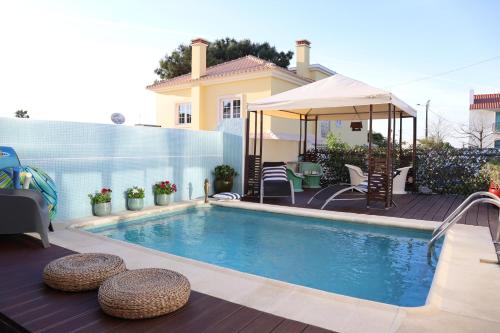 a swimming pool in front of a house at PH in Atlantic Coast in Charneca