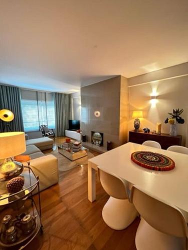 a living room with a table and a living room with a couch at Becas House - Lisboa in Lisbon