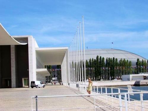 a person walking in front of a large building at Becas House - Lisboa in Lisbon