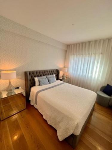 a bedroom with a large bed and a window at Becas House - Lisboa in Lisbon