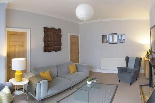 a living room with a couch and two chairs at Townhouse Apartment Carlisle in Carlisle