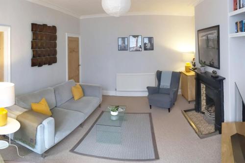 a living room with a couch and a fireplace at Townhouse Apartment Carlisle in Carlisle