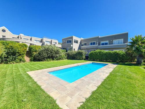 a swimming pool in the yard of a house at The beachclub 17 in Hout Bay