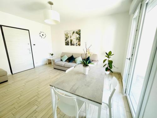 a living room with a table and a couch at Emme Apartment IUN (Q8410) in Cagliari