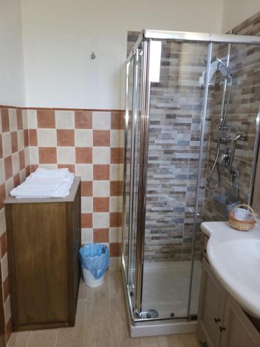 a bathroom with a shower with a sink and a toilet at Villa enza in Cinisi