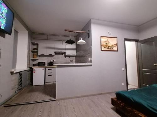 a kitchen with white walls and a counter top at Квартира - студія in Konotop