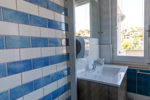 a bathroom with a sink and a window at Casa Tacconi in Villasimius
