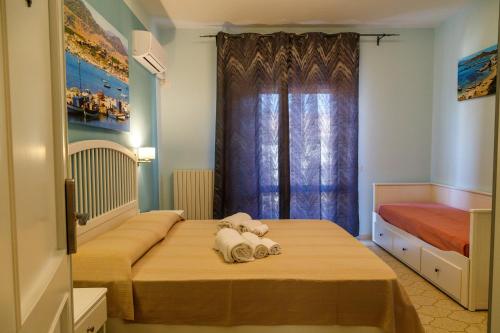 a bedroom with two beds and a window at Casa Tacconi in Villasimius