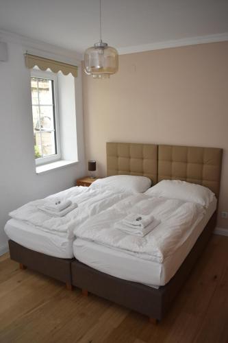 a bedroom with a large bed with two towels on it at Alte Post Greifenstein in Greifenstein