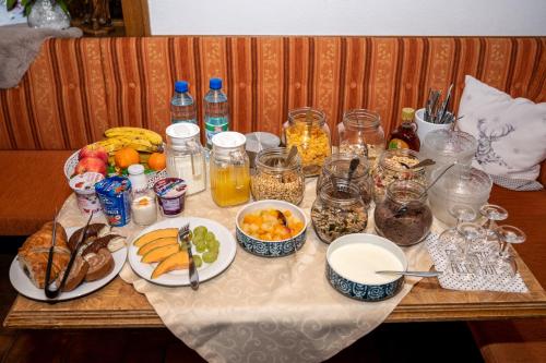 a table topped with plates of food and drinks at Garni Samnaun in Kappl