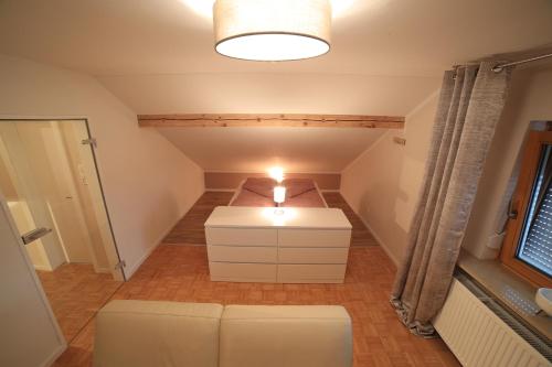a small attic room with a bed and a couch at FerienNest Kelheim in Kelheim