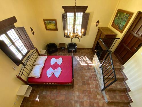 a bedroom with a bed with a red blanket at Castle Tower apartment in rural holiday park 'Bernard' in Tolox