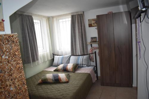 a small bedroom with a bed and a window at Prosili in Aiándion