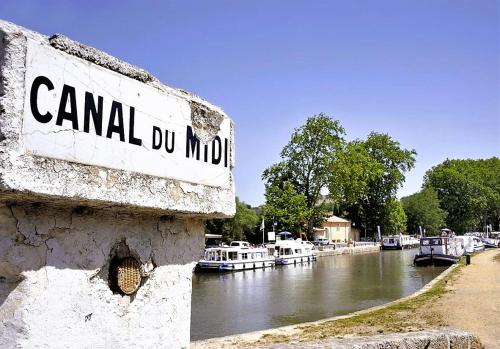 a sign that reads canal du mmo next to a river at Chambre Indépendante Piscine, Parc, Cuisine... in Brézilhac