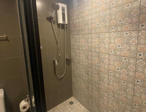 a shower in a bathroom with a phone on the wall at La casita Huahin by Pikul in Hua Hin