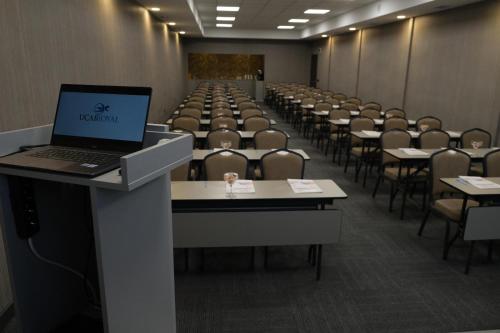 a room with a laptop on a podium in a room with chairs at Uçar Royal Hotel ve Konferans Salonu in Sile
