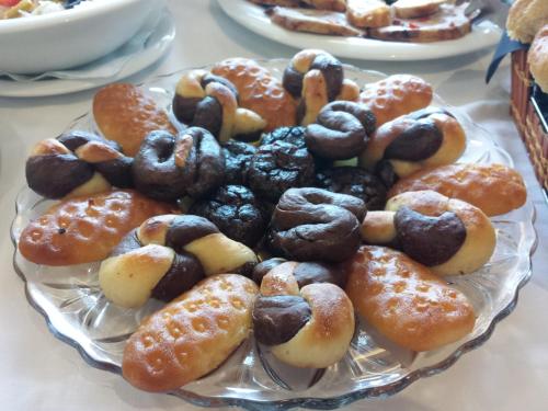 a plate of different types of donuts on a table at Hotel Malta in Mostar