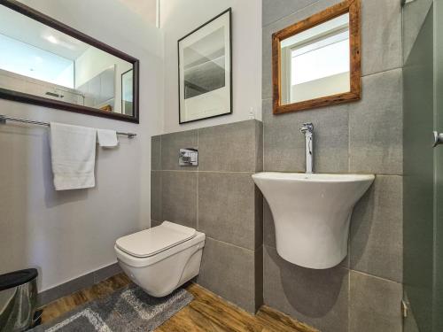 a bathroom with a toilet and a sink at The beachclub 17 in Hout Bay