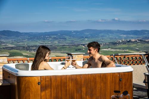 a man and a woman sitting in a bath tub at Agri Apartment La Terrazza La Ripadoro in Chianni