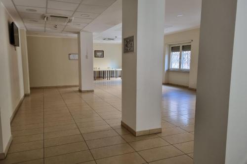 an empty hallway with white walls and a tile floor at Palazzo Sant'Antonio in Rome