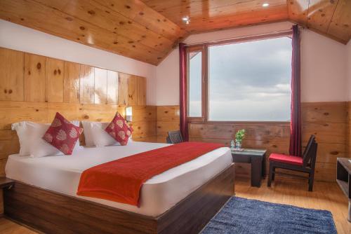 a bedroom with a bed and a desk and a window at Mountain View New Kufri in Cheog