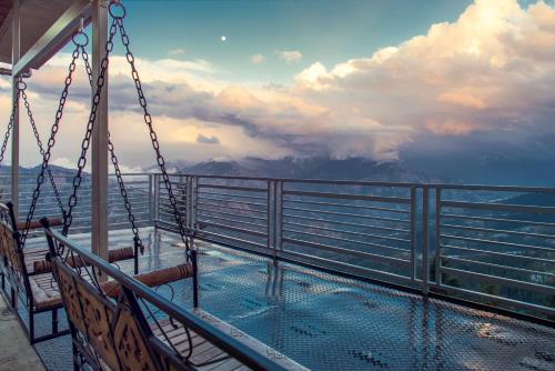 a balcony on a cruise ship with a view of the mountains at Mountain View New Kufri in Cheog