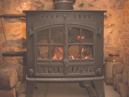 a stove with a fire inside of it at Duke of Wellington Inn in Corbridge