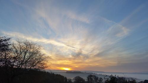 a sunset with the sun setting in the sky at Duke of Wellington Inn in Corbridge