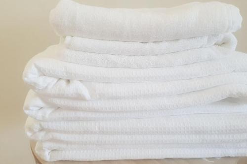 a stack of white towels stacked on top of each other at New Spacious Two Bedroom Center with Parking, near Public Transport in Luxembourg