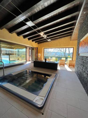 a large room with a pool in the middle of a house at Colle Indaco Wine Resort & Spa in Ortezzano