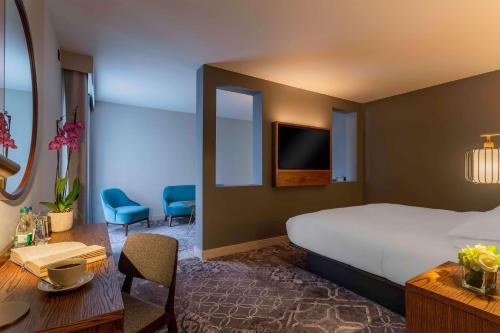 a hotel room with a bed and a table and chairs at Hyatt Centric The Liberties Dublin in Dublin