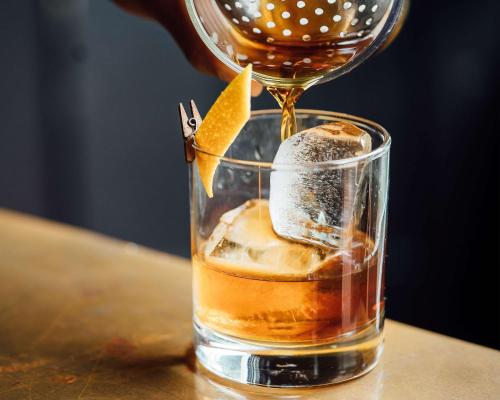 a drink being poured into a glass on a table at Hyatt Centric The Liberties Dublin in Dublin