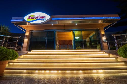 a building with stairs in front of it at night at Belcehan Hotel in Oludeniz