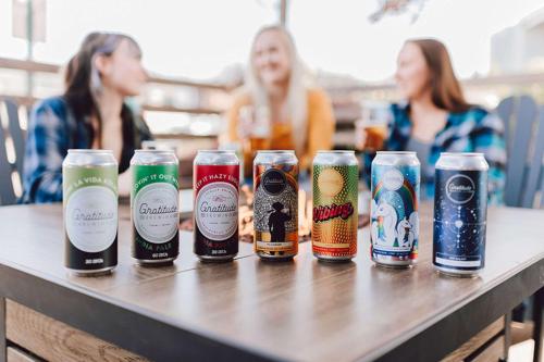 a row of beer cans sitting on a table at The Maverick Hotel Eugene near University in Eugene