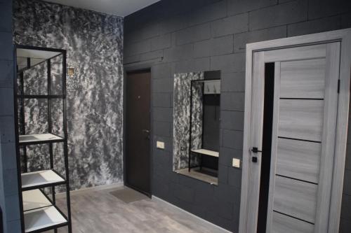 a room with a wall with two mirrors and a door at Квартира лофт-стиль in Konotop