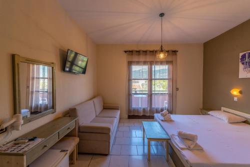 a living room with a couch and a table at Natasa Hotel in Skala Potamias