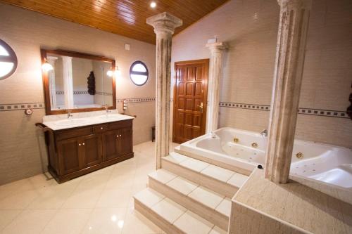 a large bathroom with a tub and a sink at Catalunya Casas Divine and Delightful for 24 guests 12km to Sitges in Olerdola