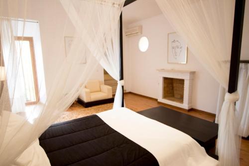 a bedroom with a bed and a fireplace at Catalunya Casas Divine and Delightful for 24 guests 12km to Sitges in Olerdola