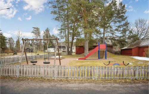 een speeltuin met een glijbaan en een schommel bij 5 Bedroom Lovely Apartment In Mlilla in Målilla