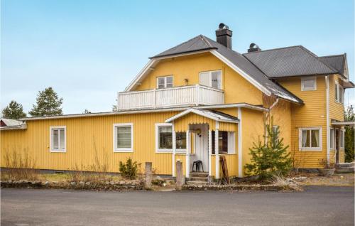a yellow house with a white door and a porch at Gorgeous Apartment In Målilla With Wifi in Målilla