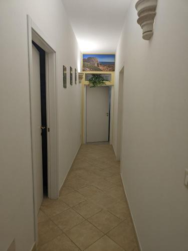 a hallway with a door and a tile floor at Villa Nel Verde - Bonsignore in Tricase