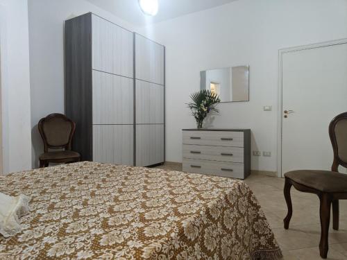 a bedroom with a bed and a dresser and a mirror at Villa Nel Verde - Bonsignore in Tricase