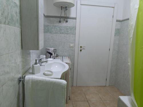 a white bathroom with a sink and a mirror at Villa Nel Verde - Bonsignore in Tricase